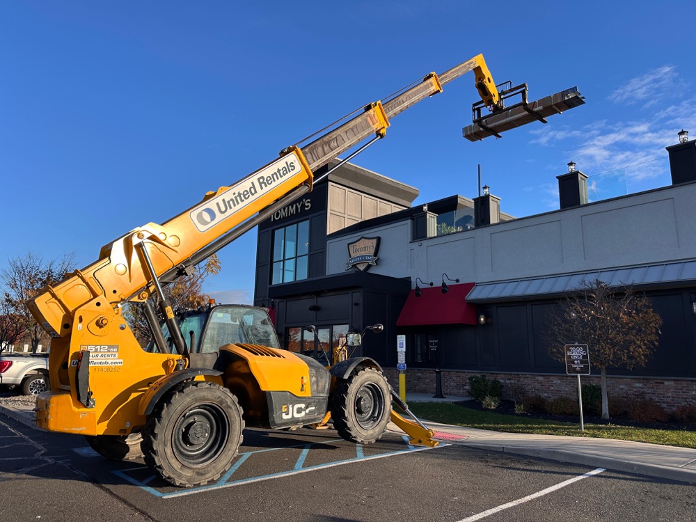 Heavy equipment crane at Tommy's Tavern installation — commercial scale