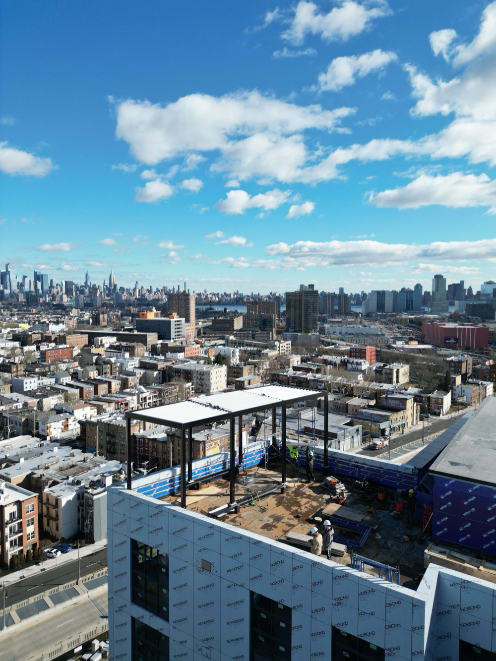 Rooftop louvered roof installation with NYC skyline